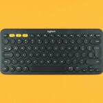black logitech keyboard on orange surface