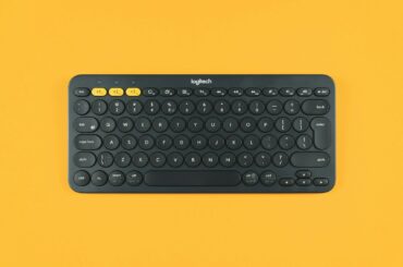 black logitech keyboard on orange surface